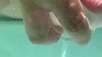 Cream pie and dildo in pussy are submerged in water.