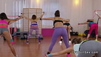 At the gym, three horny lesbians are having fun.