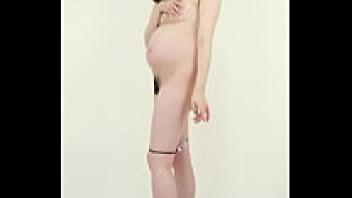 A pregnant woman is attempting to preserve a photograph of herself in her underwear as a memento of her pregnancy.