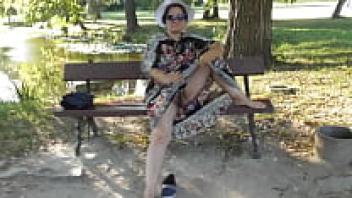 In the park, a mature and hairy person flashing