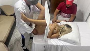 Despite the fact that my wife is being examined by a gynecologist, I have a feeling that he is in love with her next to me, and my wife is pleased with this.