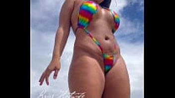 Kriss Hotwife wearing a mini bikini as she is on the beach