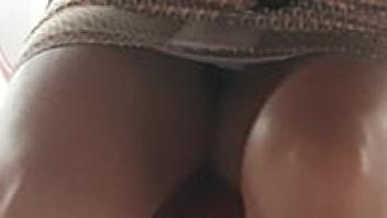 Little girl positioned beneath the table, wearing a miniskirt and spreading her legs apart