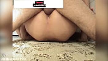 In the kitchen of their house, a couple records a crude sexual video.