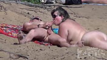 A blowjob performed on a beach for nudists