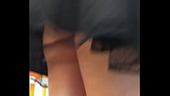 There is a lovely girl in the market wearing an upskirt.