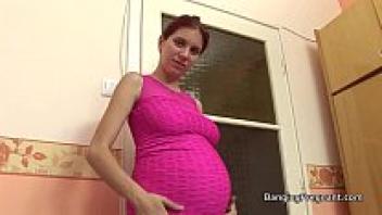A redhead who is pregnant and taking a large black cock