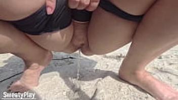 A older, chubby pussy urinating on a public beach