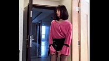 An Asian ladyboy flashes her dick to a woman while masturbating, and cum