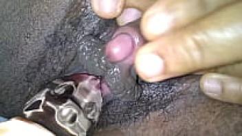 Alundra, an ebony beauty, shoves a glass toy deep into.