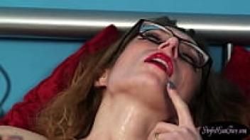 Babe in glasses spreads cumshot all over her face.