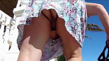 In public, behind the skirts of a chubby babe wearing split panties