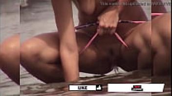 On the beach, my friend's girlfriend is urinating.