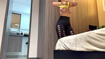 A spy camera shows a fitness model (LEGGIN, BIG TITS, BIG ASS, LATINA) getting ready to go to the gym.