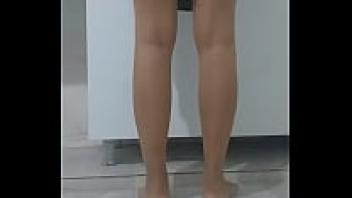 While doing the dishes, a Turkish woman wearing a headscarf reveals her upskirt.